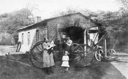 Familie Grüning vor Werkstatt-Scheune in Krempel Historischer Abriss